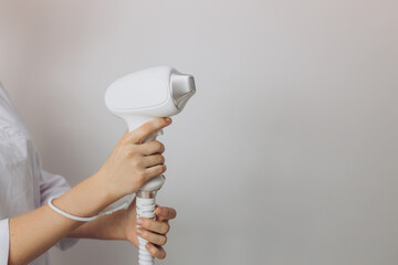 Laser device for removing unwanted hair in the hand of nurse. Laser hair removal, cosmetic body...