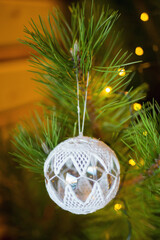 Christmas tree ball on a pine branch