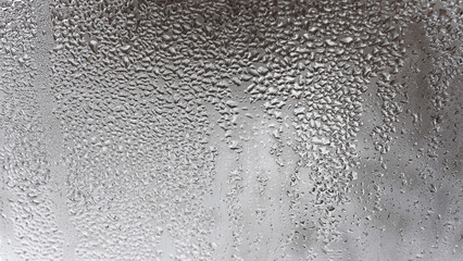Close up for misted glass with droplets of water draining down. Dripping Condensation, Water Drops Background Rain drop Condensation Texture