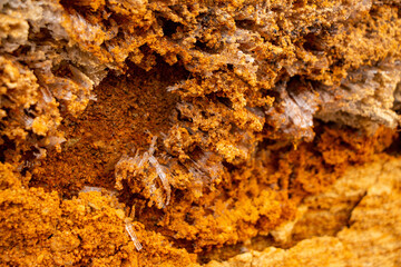 Textural sand, with  relief surface, multi-colored layers and different in size of granules, in outdoor sand career, after mining ore and sand for construction.
