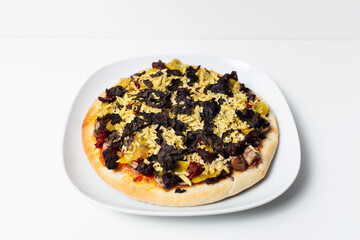 Close-up view of homemade vegan pizza on white background.