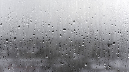 Steamy window with water drops on surface of shower cabin as background blurred Image