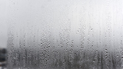 Steamy window with water drops on surface of shower cabin as background blurred Image