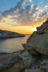 Fototapeta na wymiar sunset on the coast in matala, creta, greece - matala sunset