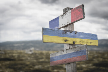 france ukraine russia flag on wooden signpost outdoors in nature. Conflict in ukraine concept.