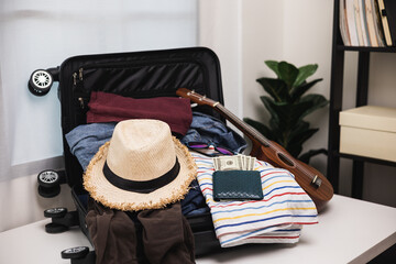 Organize luggage. Put clothes and pants in trolley bag and prepare to go abroad. Preparing suitcase for summer vacation trip. Traveler accessories open luggage.