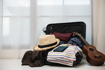 Organize luggage. Put clothes and pants in trolley bag and prepare to go abroad. Preparing suitcase for summer vacation trip. Traveler accessories open luggage.