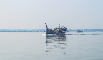 Obraz premium Photo of Industrial fishing boat. Fishing boat in the sea. The fishing industry in India. Indian traditional fishing boat.