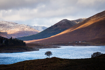 Autumn landscape in Highlands, Scotland, United Kingdom. Beautiful mountains with snow in background.