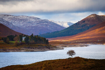 Autumn landscape in Highlands, Scotland, United Kingdom. Beautiful mountains with snow in background.