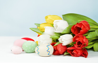 bouquet of tulips and easter eggs on a light background