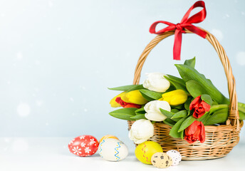bouquet of tulips in a wicker basket and easter eggs