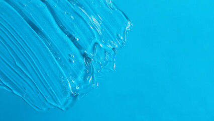 Texture of the cosmetic gel on the blue background.Copy space for text,mockup concept,large banner.