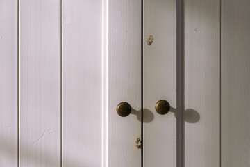brass knobs on wooden cabinet doors
