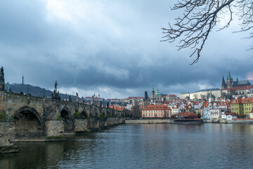The famous Carles-Bridge in Prague on a cold winter day with a dramatic sky