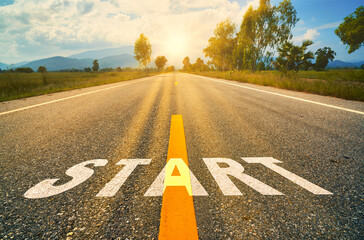 Start written on the asphalt road  sunset.Concept of challenge or career path and change.