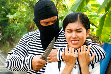 Crime concept : Robbery and sexual assault : The face is used as a weapon to lock a girl's throat...