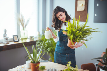 Lovely housewife with flower in pot and gardening set. Gardening is more than hobby.Lovely...