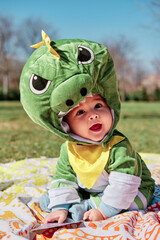 Baby dressed in a dinosaur costume