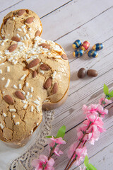 Easter breakfast in Italy whit Colomba cake and little chocholat eggs on wooden surface