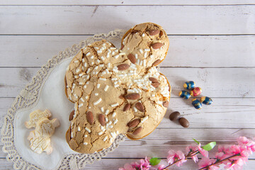 Easter breakfast in Italy whit Colomba cake and little chocholat eggs on wooden surface