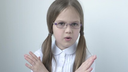 Child in uniform and glasses says no to war protect our children. No violence and assault. Little girl making stop gesture, expressing denial or restriction. Negative human emotions, feelings