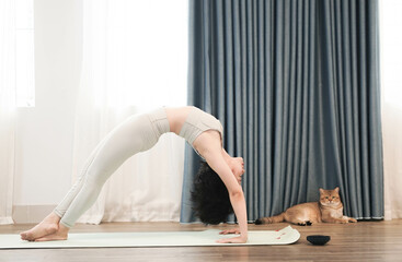 Asian girl doing yoga at home. Beautiful young asian woman practicing yoga  