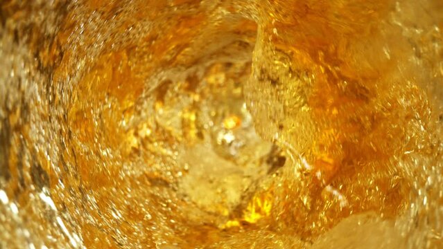 Super Slow Motion Shot of Fresh Beer Whirling in Glass Bottle at 1000fps.