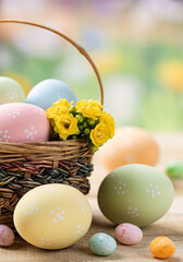 Colored easter eggs with basket and flowers