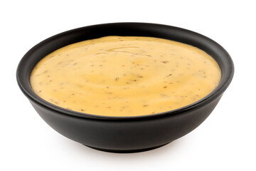 Honey and mustard sauce with dill in a black ceramic bowl.