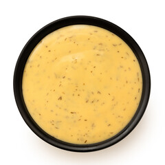 Honey and mustard sauce with dill in a black ceramic bowl. Top view.