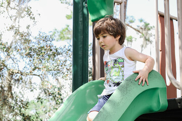 child playing in the playground of moss park in Orlando Florida.  Moss Park & Campground is located...