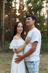 Fototapeta premium a guy and a girl on a date in a pine forest