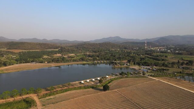Orbital Aerial Panning Shot of a Lake and Resort in Phetchaburi, Thailand on a Summers Day with Blue Skies.