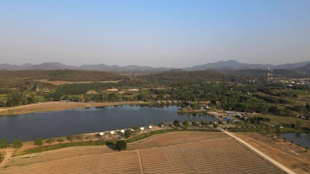 Aerial Footage with Orbital Pan of a Lake and Resort in Thailand with Beautiful Scenery.