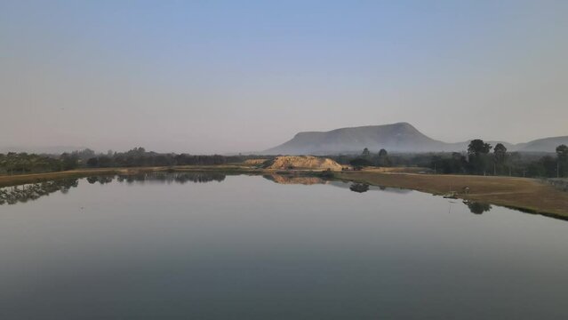 Amazing Reflections of a Lake and Mountain Shot with a Drone Rising Upward Revealing the Landscape with Early Morning Mist.