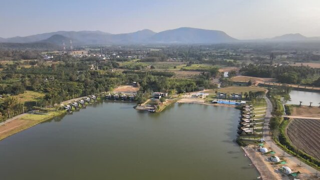 Aerial Footage of a Lake and Hotel Resort Pulling Back with Beautiful Scenery.
