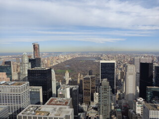 new york city top of view in front of central park with a blue sky