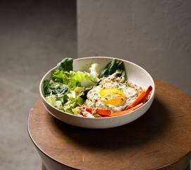 Plate with breakfast salads: brown rice, carrots, egg