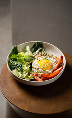 Plate with breakfast salads: brown rice, carrots, egg