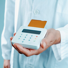 doctor has a payment terminal in his hand