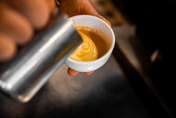 Barista hand making cappuccino Coffee with espresso and milk in cafe