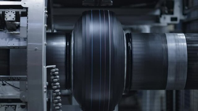 Automated tyre production technology view at modern industrial factory closeup