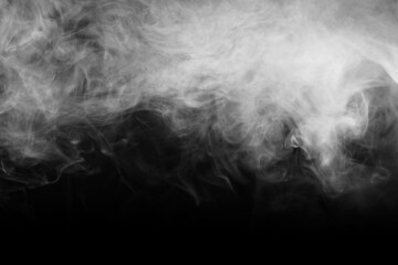 Abstract smoke texture over black. Fog in the darkness.