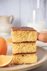 orange cake cut into pieces with ingredients and milk, sweet and delicious dessert