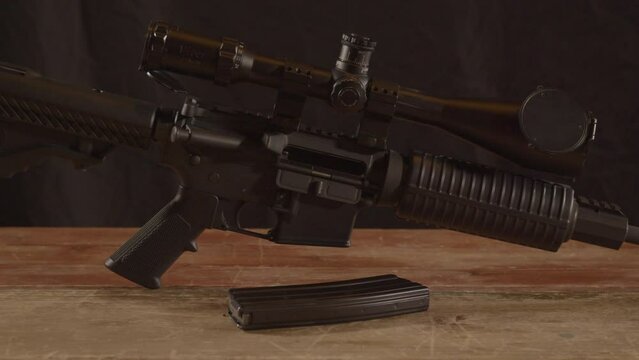 Dolly out of unloaded AR-15 on a wooden surface