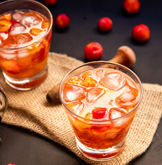 Acerola(Barbados Cherry) Caipirinha, Traditional alcoholic drink from Brazil in Dark background.