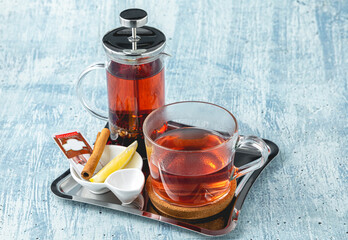 Hot winter tea served with a french press on a wooden table