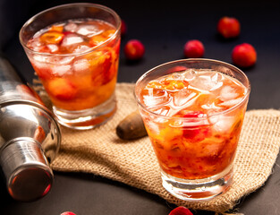 Acerola(Barbados Cherry) Caipirinha, Traditional alcoholic drink from Brazil in Dark background.