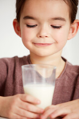 Mmmmmmmm milk. Cropped shot of a cute little girl looking happily at a glass of milk.